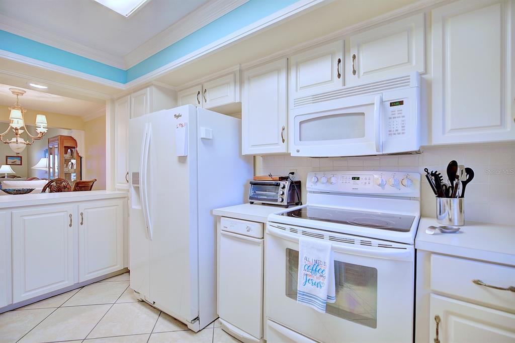 2025 Sylvester Road, Unit H2 Lakeland, FL 33803 - Photo 13 of 59 a kitchen with white cabinets and white appliances