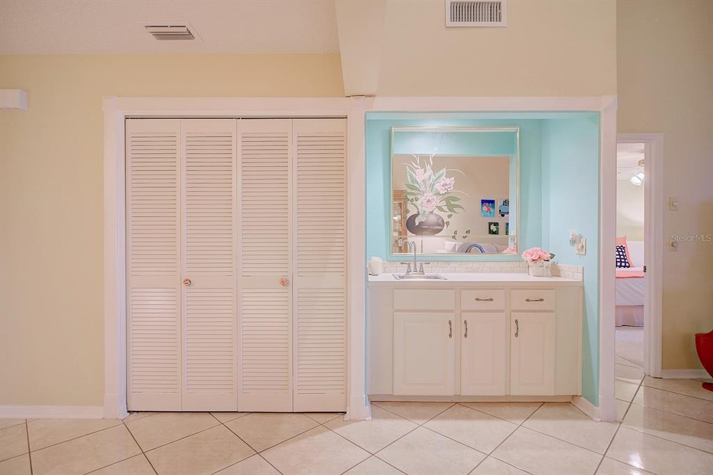2025 Sylvester Road, Unit H2 Lakeland, FL 33803 - Photo 19 of 59 a bathroom with a granite countertop sink a mirror and a vanity