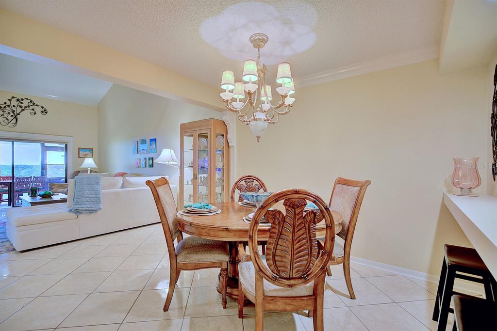 2025 Sylvester Road, Unit H2 Lakeland, FL 33803 - Photo 20 of 59 a dining room with furniture and chandelier