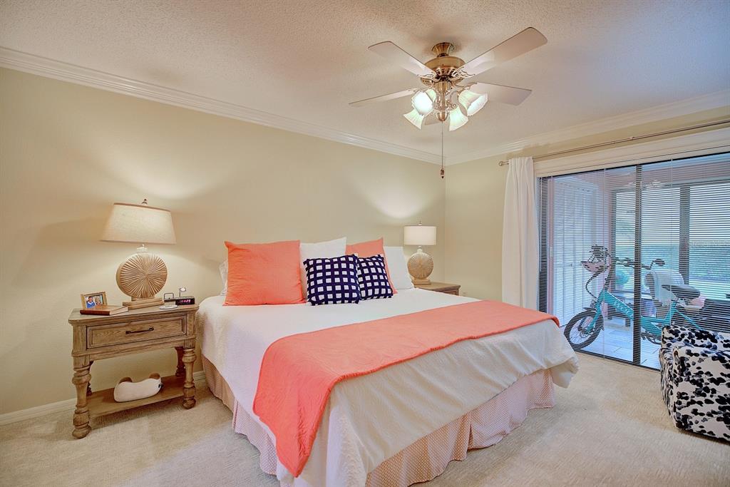 2025 Sylvester Road, Unit H2 Lakeland, FL 33803 - Photo 24 of 59 a bedroom with a bed and dresser with mirror