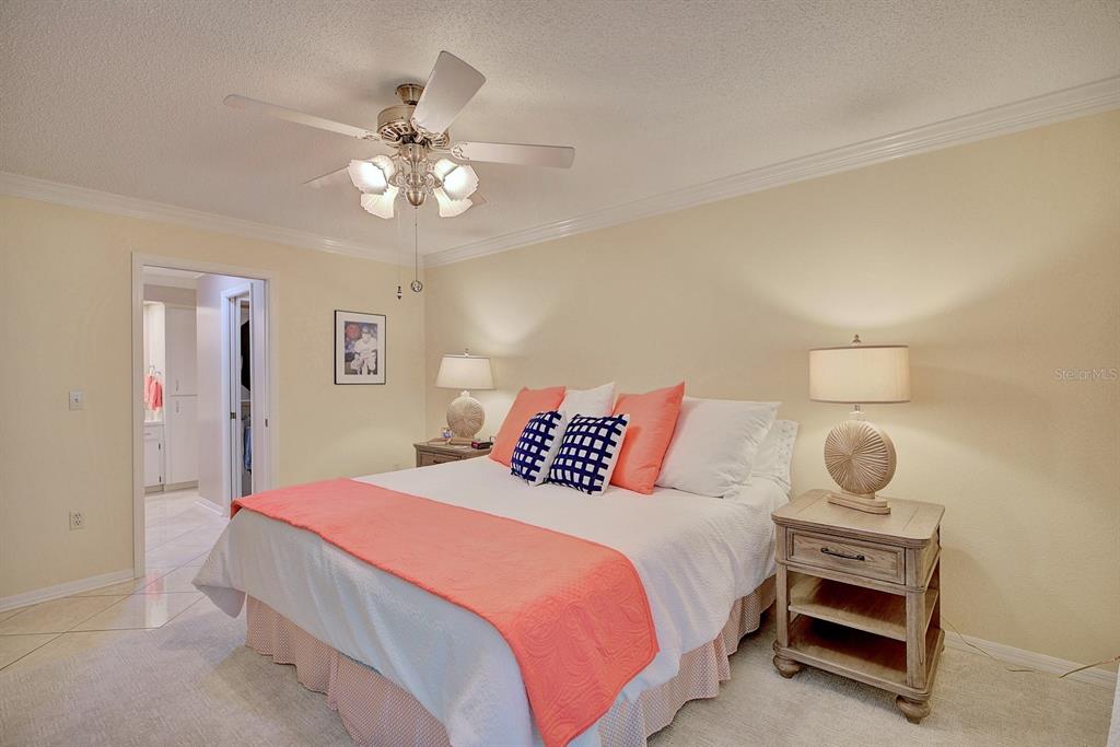 2025 Sylvester Road, Unit H2 Lakeland, FL 33803 - Photo 27 of 59 a bedroom with a bed and a chandelier