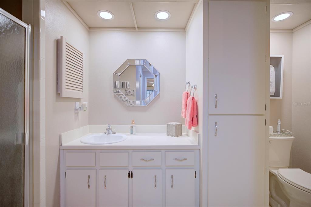 2025 Sylvester Road, Unit H2 Lakeland, FL 33803 - Photo 33 of 59 a bathroom with a sink a mirror and a toilet