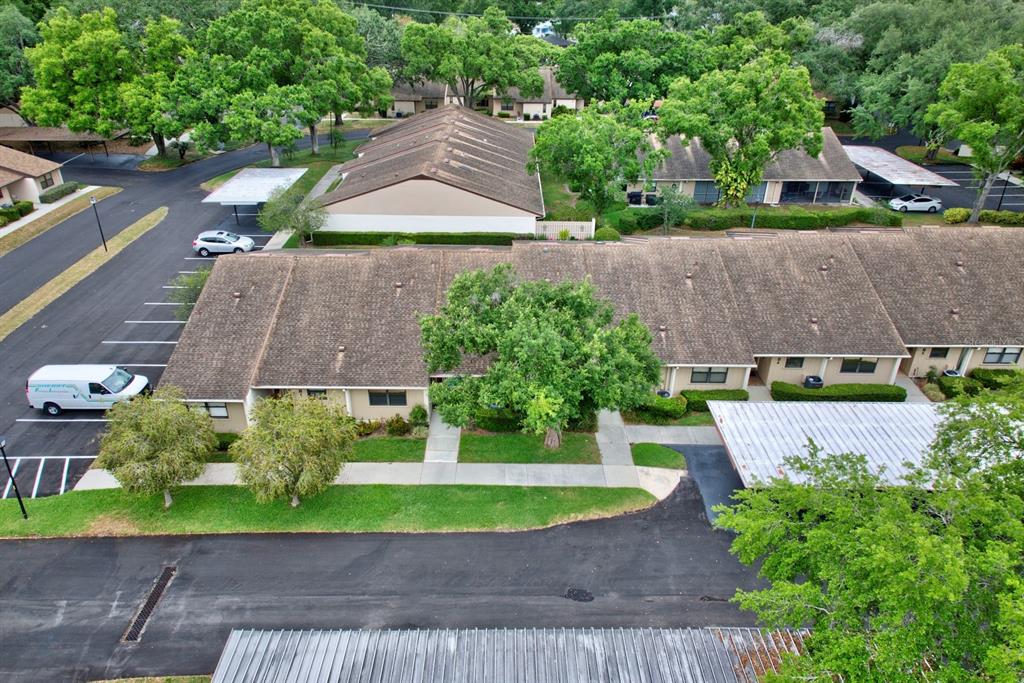 2025 Sylvester Road, Unit H2 Lakeland, FL 33803 - Photo 4 of 59 an aerial view of a house with a yard and a large tree