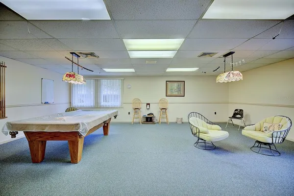 a view of a house with a yard and large trees