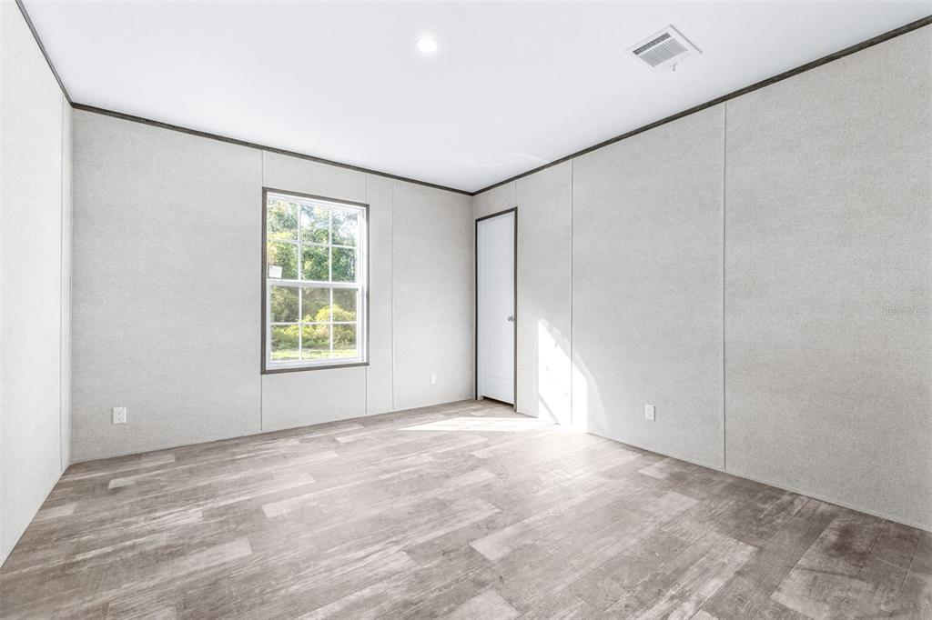 892 Southwest 124th Lane Webster, FL 33597 - Photo 14 of 29 a view of an empty room with a window