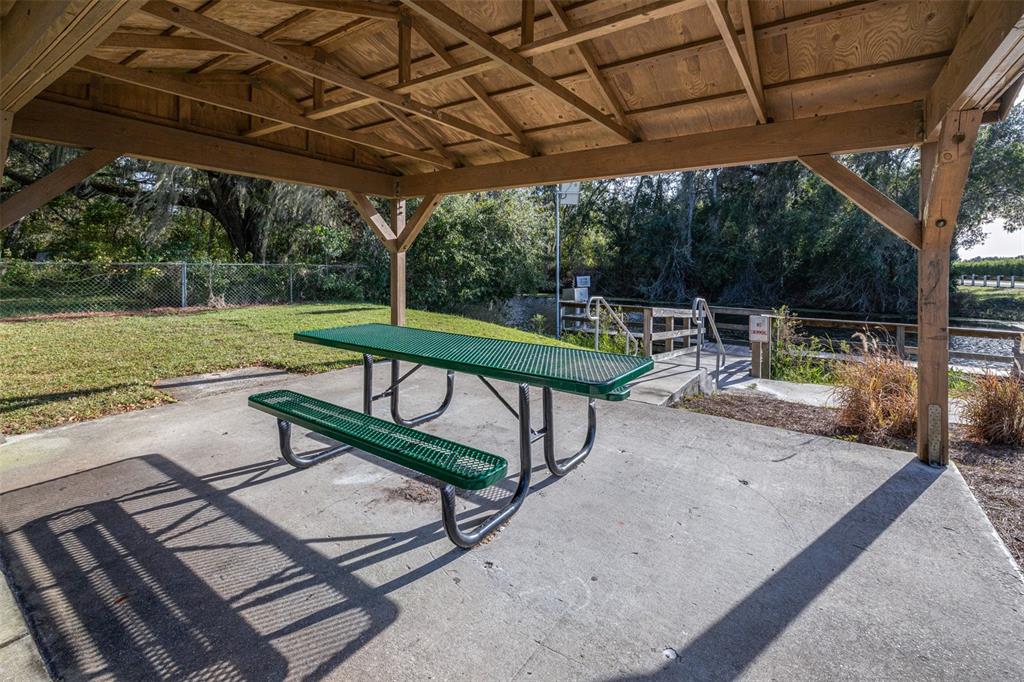 892 Southwest 124th Lane Webster, FL 33597 - Photo 28 of 29 a view of a patio with a table chairs and a backyard