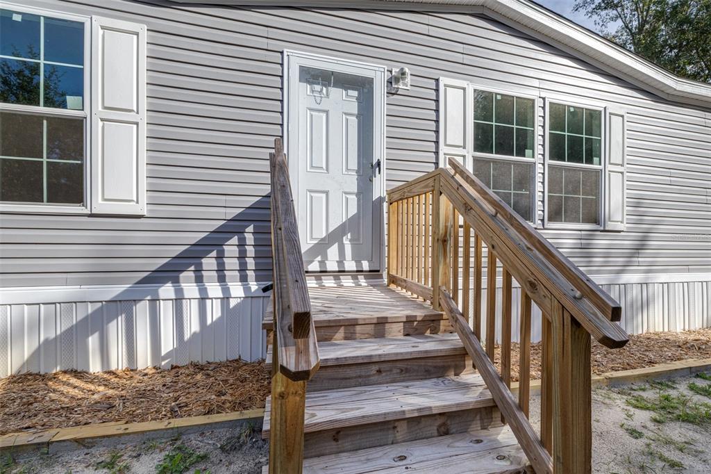 892 Southwest 124th Lane Webster, FL 33597 - Photo 4 of 29 a view of staircase with wooden floor and fence