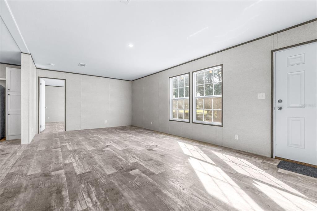 892 Southwest 124th Lane Webster, FL 33597 - Photo 6 of 29 a view of an empty room with a window