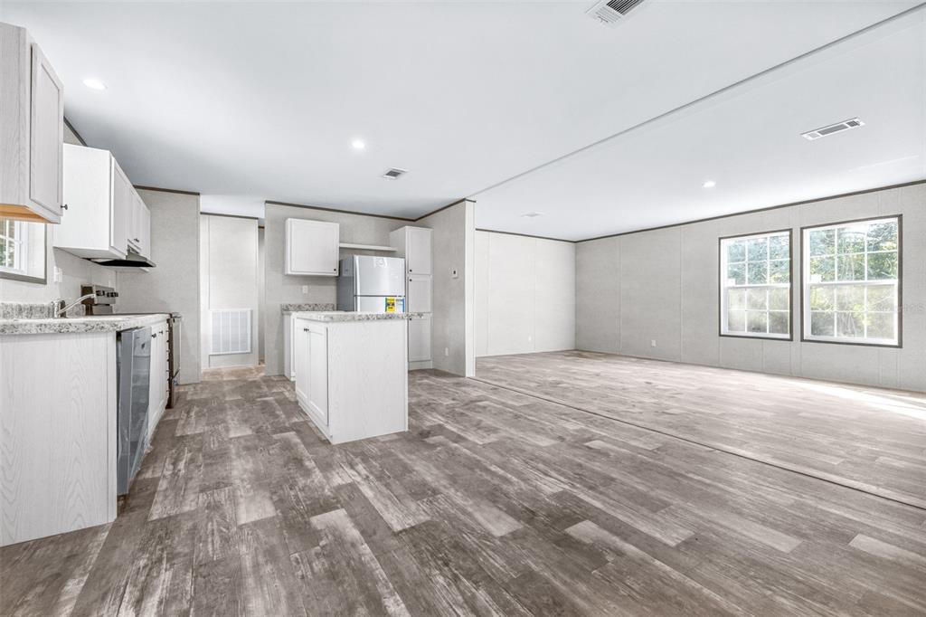 892 Southwest 124th Lane Webster, FL 33597 - Photo 7 of 29 a view of a kitchen with a sink cabinets and wooden floor