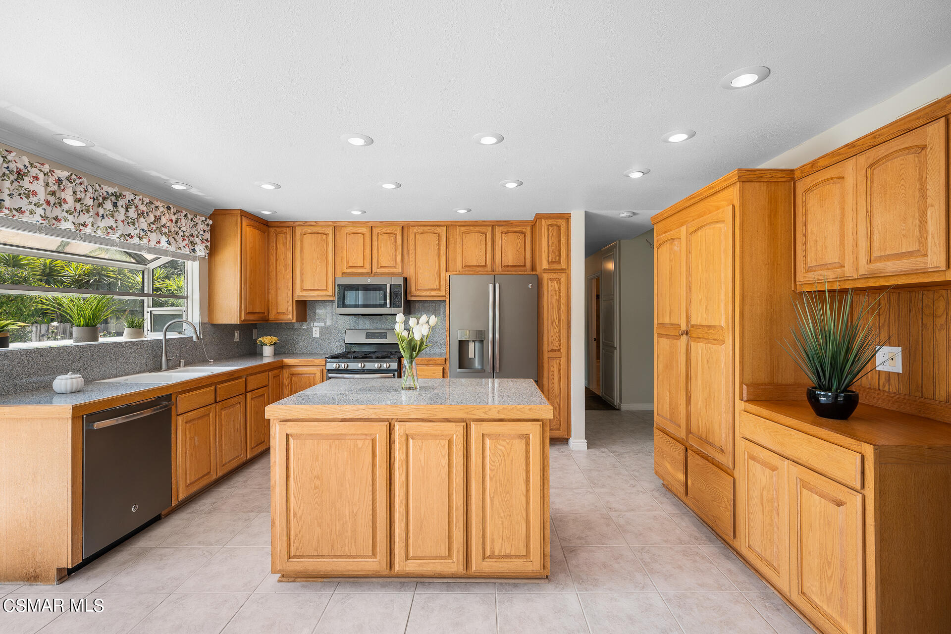 3092 Big Sky Drive Thousand Oaks, CA 91360 - Photo 19 of 66 a kitchen with stainless steel appliances granite countertop a stove a sink and a refrigerator