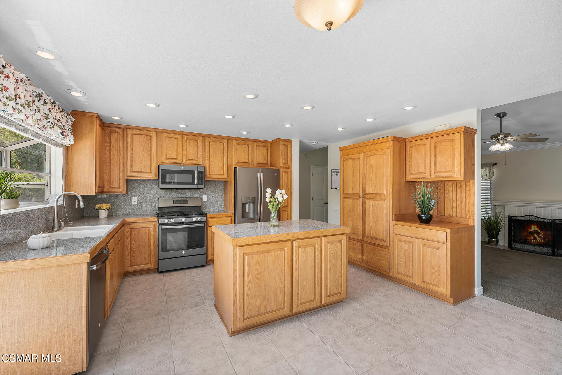 3092 Big Sky Drive Thousand Oaks, CA 91360 - Photo 3 of 66 a kitchen with stainless steel appliances a stove a refrigerator a sink a oven with white cabinets and wooden floor