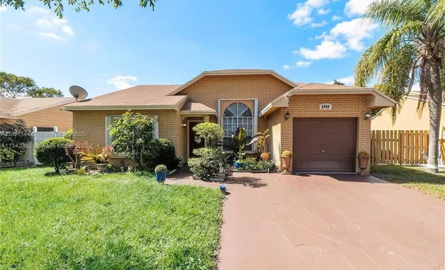 a front view of a house with yard and outdoor seating