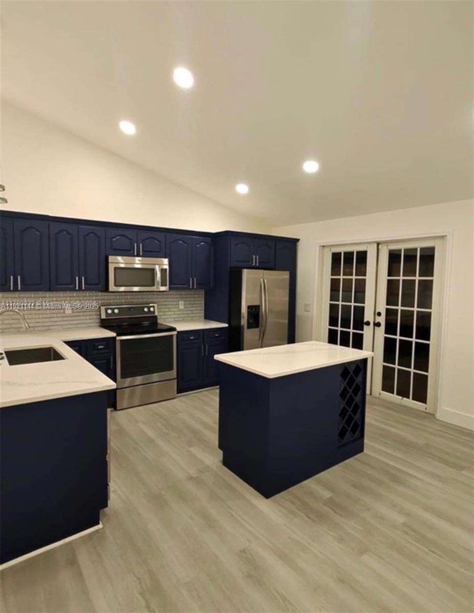 1430 Southwest 85th Terrace Pembroke Pines, FL 33025 - Photo 11 of 27 a large kitchen with stainless steel appliances a large counter top