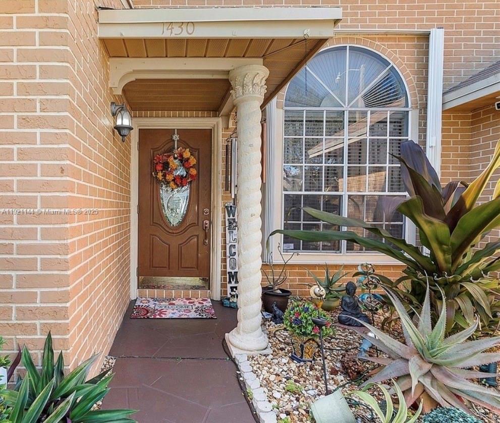 1430 Southwest 85th Terrace Pembroke Pines, FL 33025 - Photo 2 of 27 a front view of a house with garden