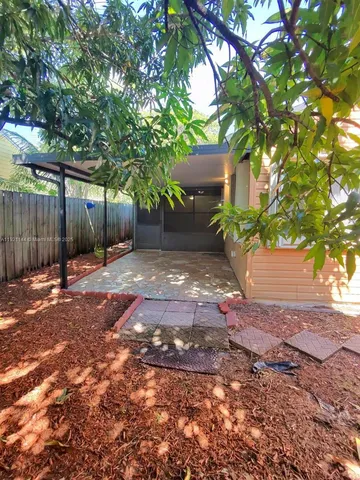 a kitchen with stainless steel appliances kitchen island granite countertop a refrigerator a stove a sink dishwasher and white cabinets with wooden floor