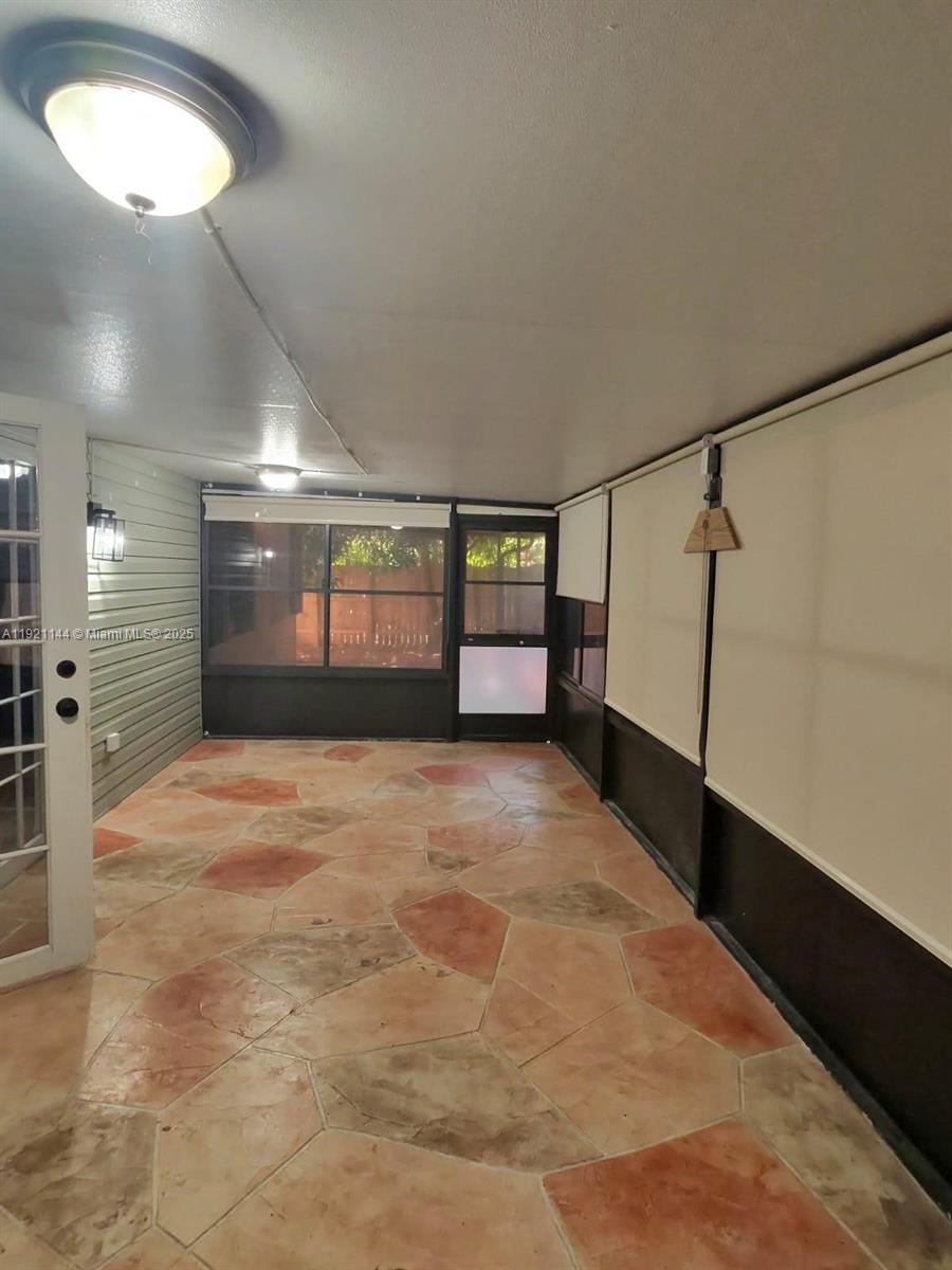 1430 Southwest 85th Terrace Pembroke Pines, FL 33025 - Photo 27 of 27 a view of empty room with wooden floor and fan