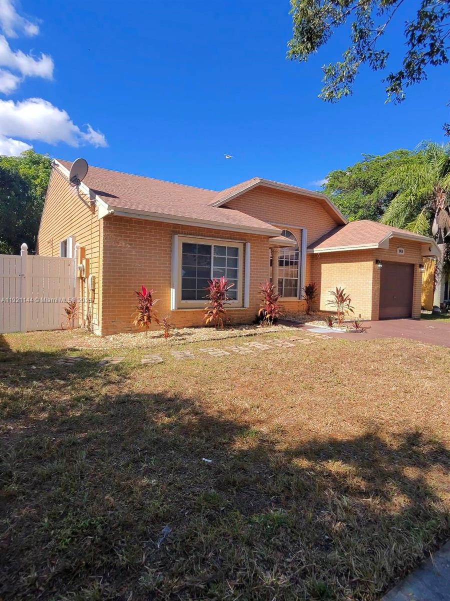 1430 Southwest 85th Terrace Pembroke Pines, FL 33025 - Photo 3 of 27 a view of a house with a yard