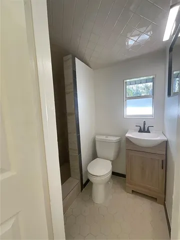 a white toilet sitting next to a bathroom sink