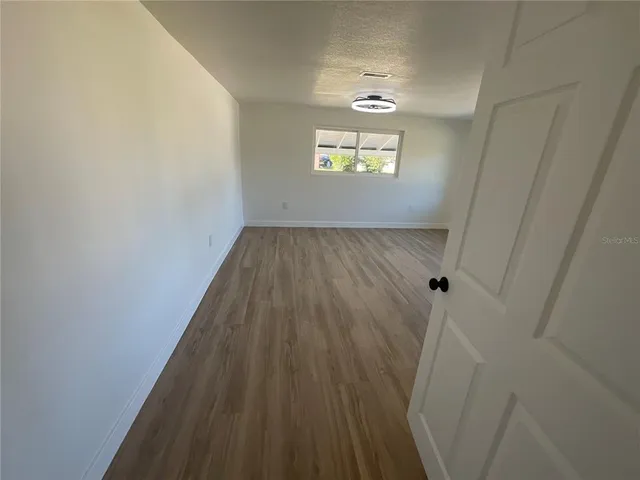 a view of an empty room and a window