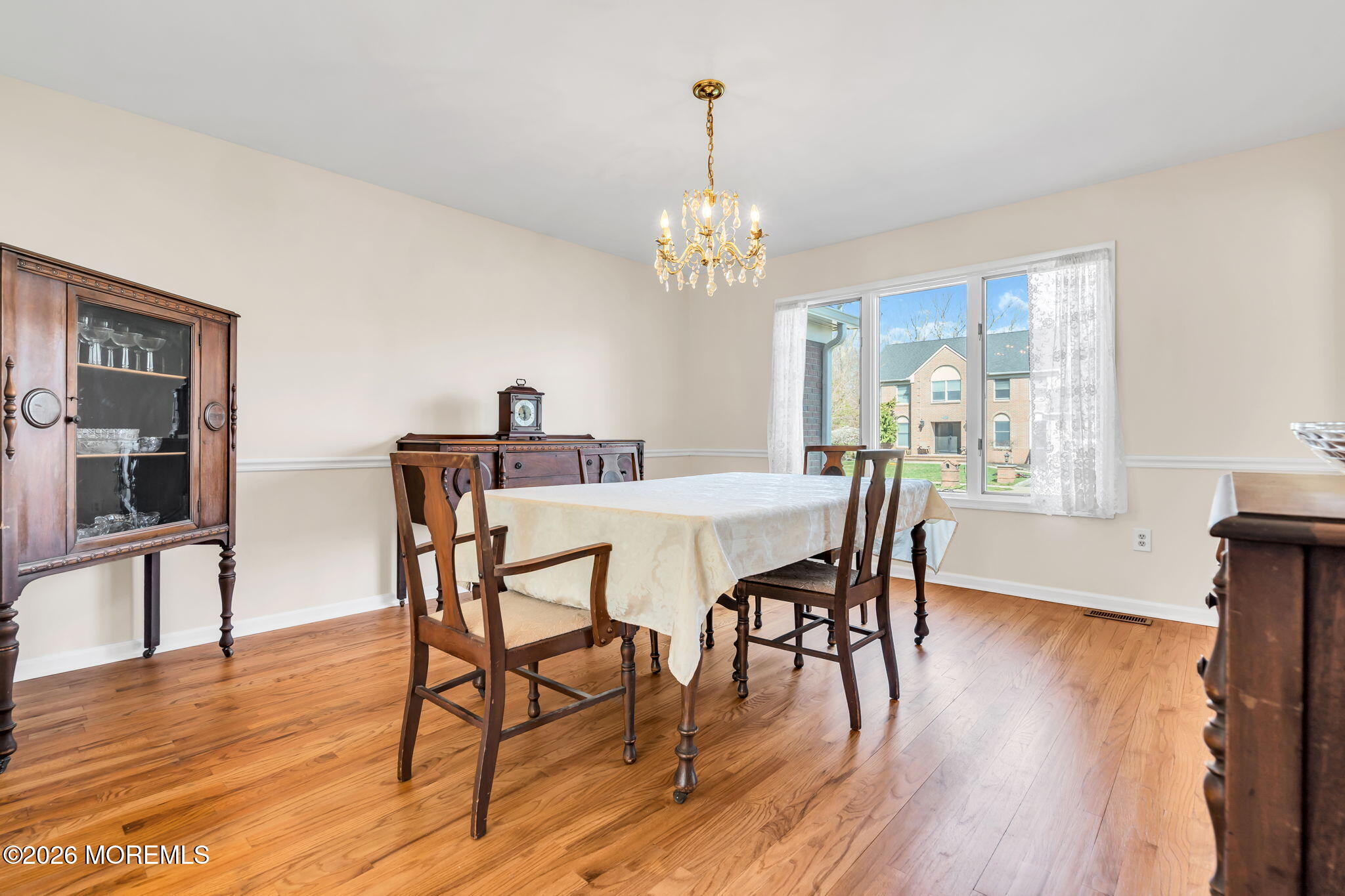 250 Bent Hook Road Toms River, NJ 08755 - Photo 23 of 63 a view of a dining room with furniture a chandelier and wooden floor