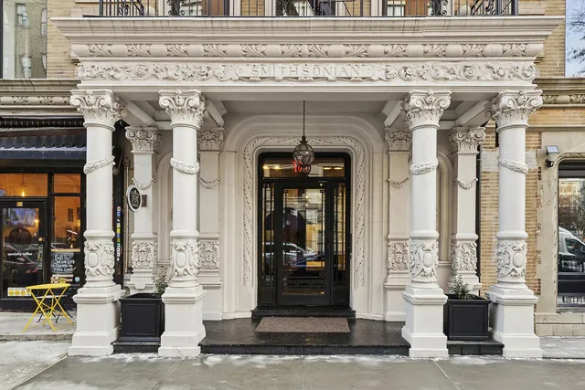 a view of a hallway with wooden floor and entryway
