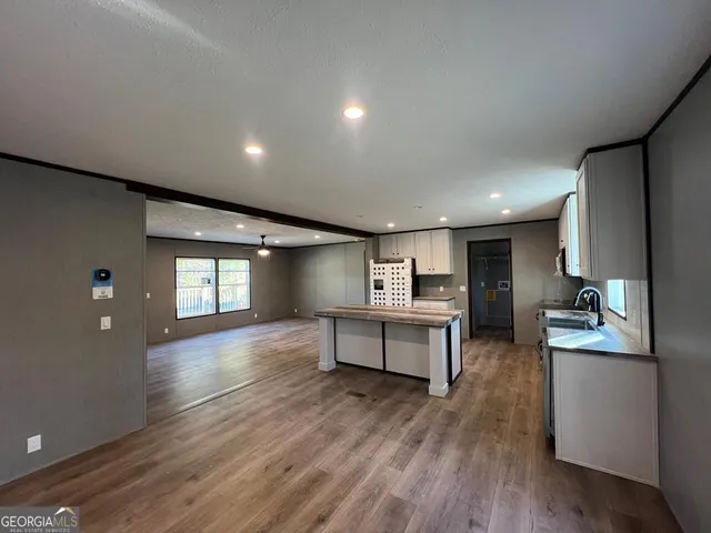 a view of a kitchen with cabinets and wooden floor