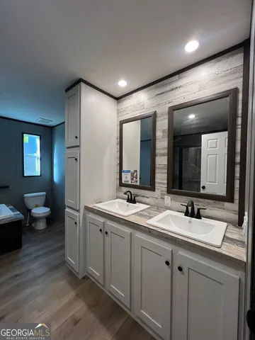 a bathroom with a double vanity sink and mirror