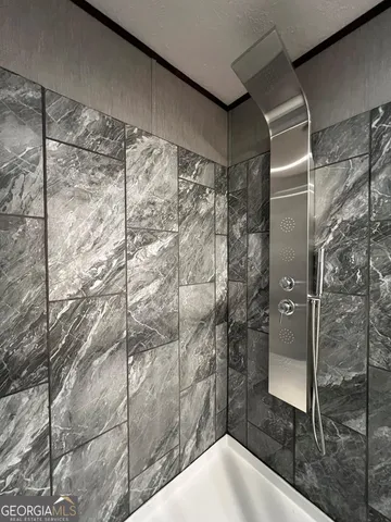 a bathroom with a shower and a sink