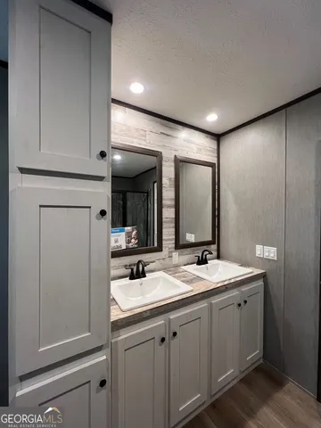 a bathroom with 2 sink and a mirror