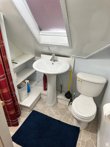 541 300 North Provo, UT 84606 - Photo 31 of 36 Pedestal sink with standard chrome faucet, white toilet, and patterned tile flooring