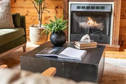 a kitchen with stainless steel appliances kitchen island granite countertop a table chairs and a refrigerator
