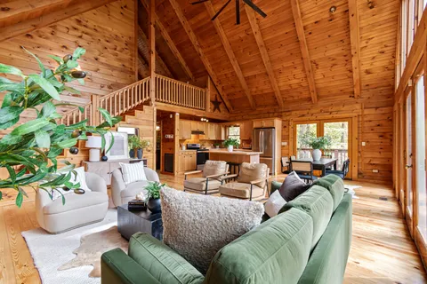 a kitchen with stainless steel appliances granite countertop a stove a sink dishwasher and a refrigerator with wooden floor