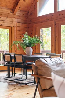a view of a kitchen with granite countertop a dining table chairs and a wooden floor