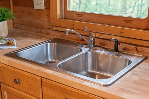 a living room with furniture a fireplace and potted plants