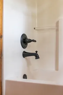 a view of a house with a yard and wooden fence