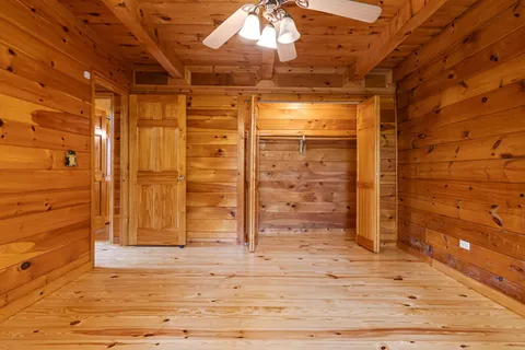an aerial view of residential houses with outdoor space and trees