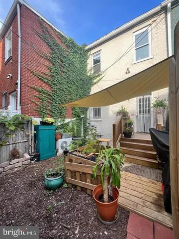 a view of a patio with chairs and potted plants