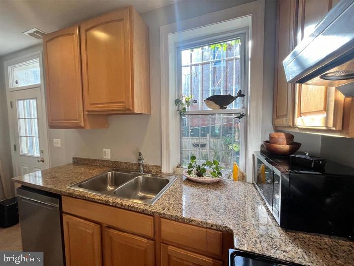 1610 4th Street Northwest Washington, DC 20001 - Photo 5 of 21 a kitchen with stainless steel appliances granite countertop a sink stove and cabinets