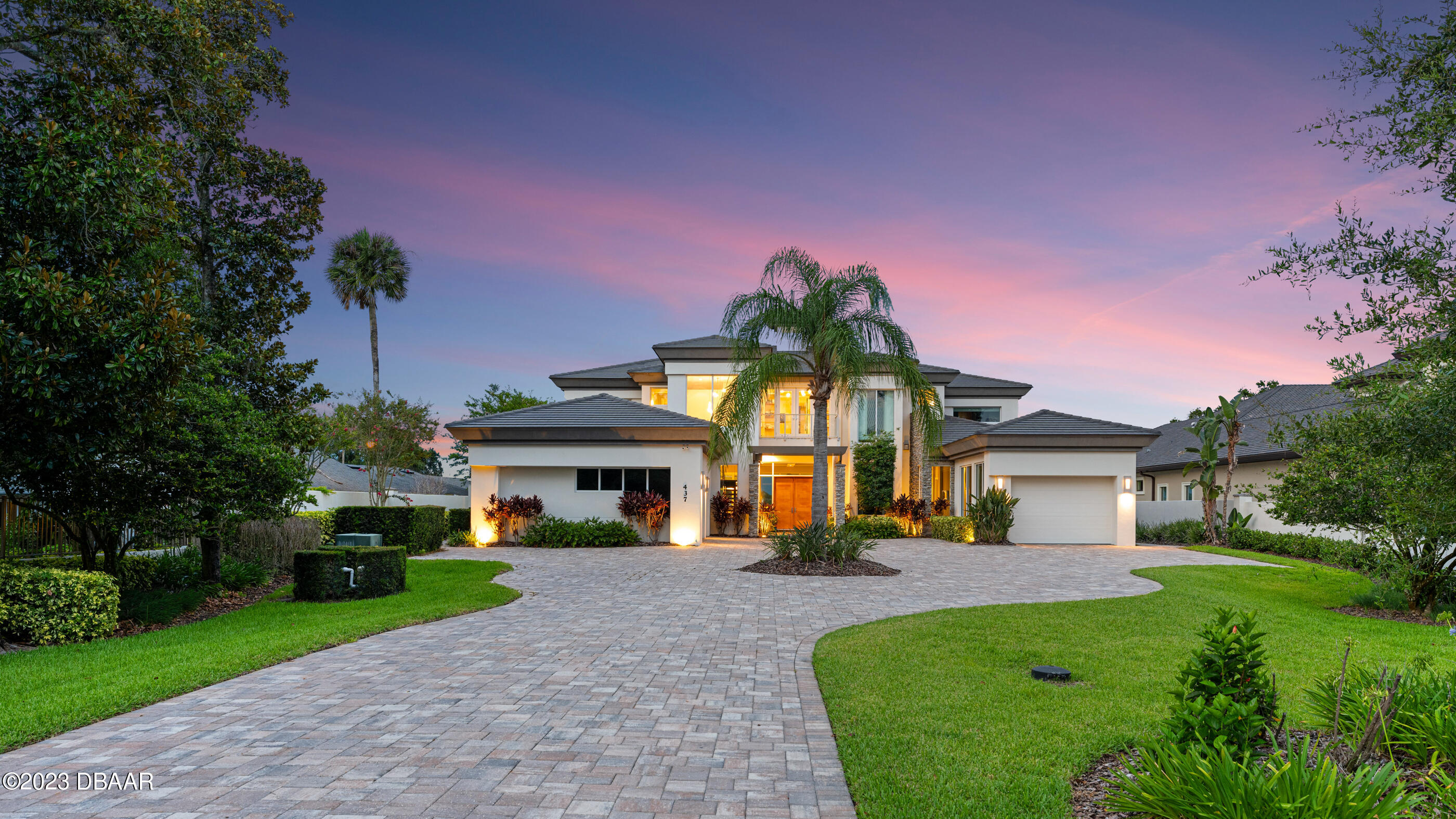 437 North Beach Street Ormond Beach, FL 32174 - Photo 122 of 162 a front view of a house with a yard and potted plants