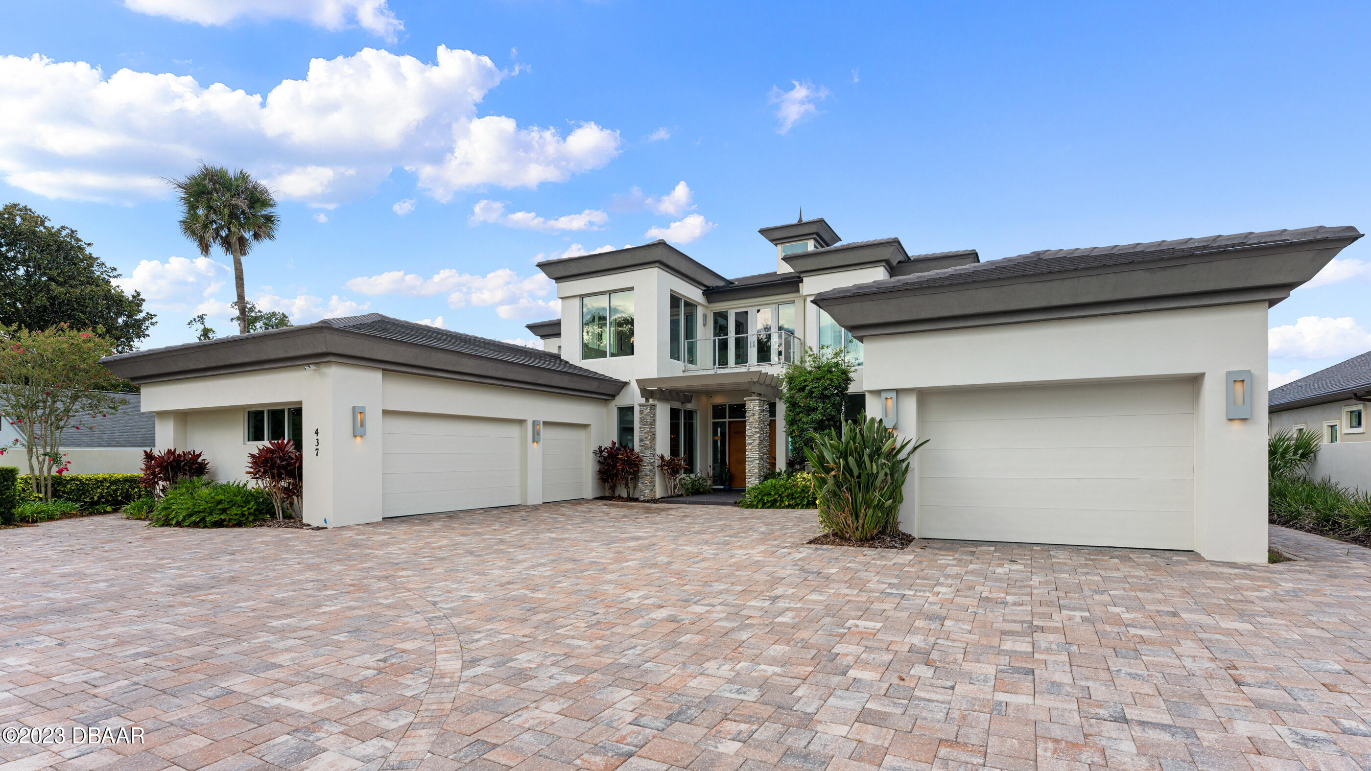 437 North Beach Street Ormond Beach, FL 32174 - Photo 124 of 162 a front view of a house with a yard and garage
