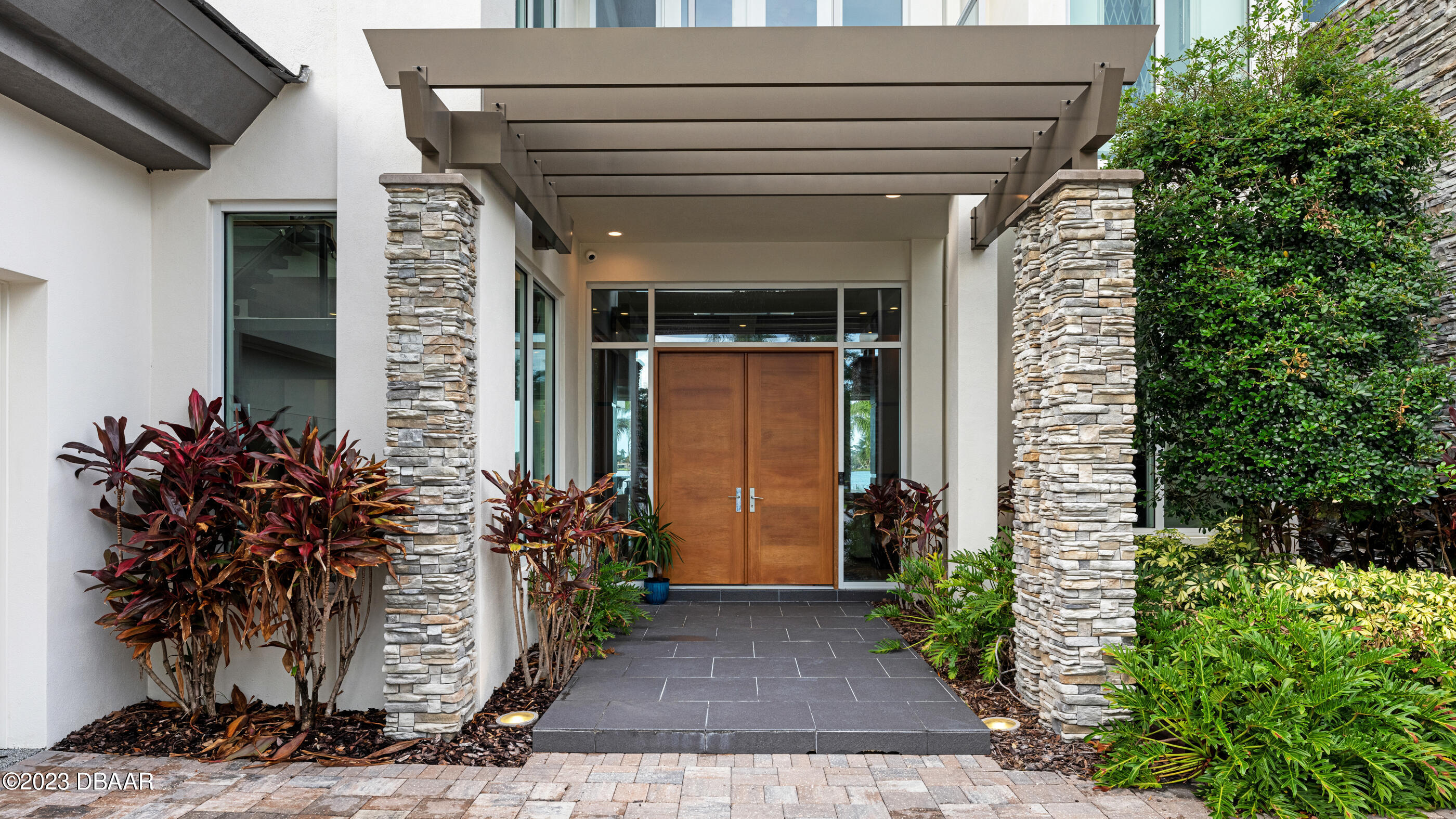 437 North Beach Street Ormond Beach, FL 32174 - Photo 127 of 162 a potted plant sitting in front of a house