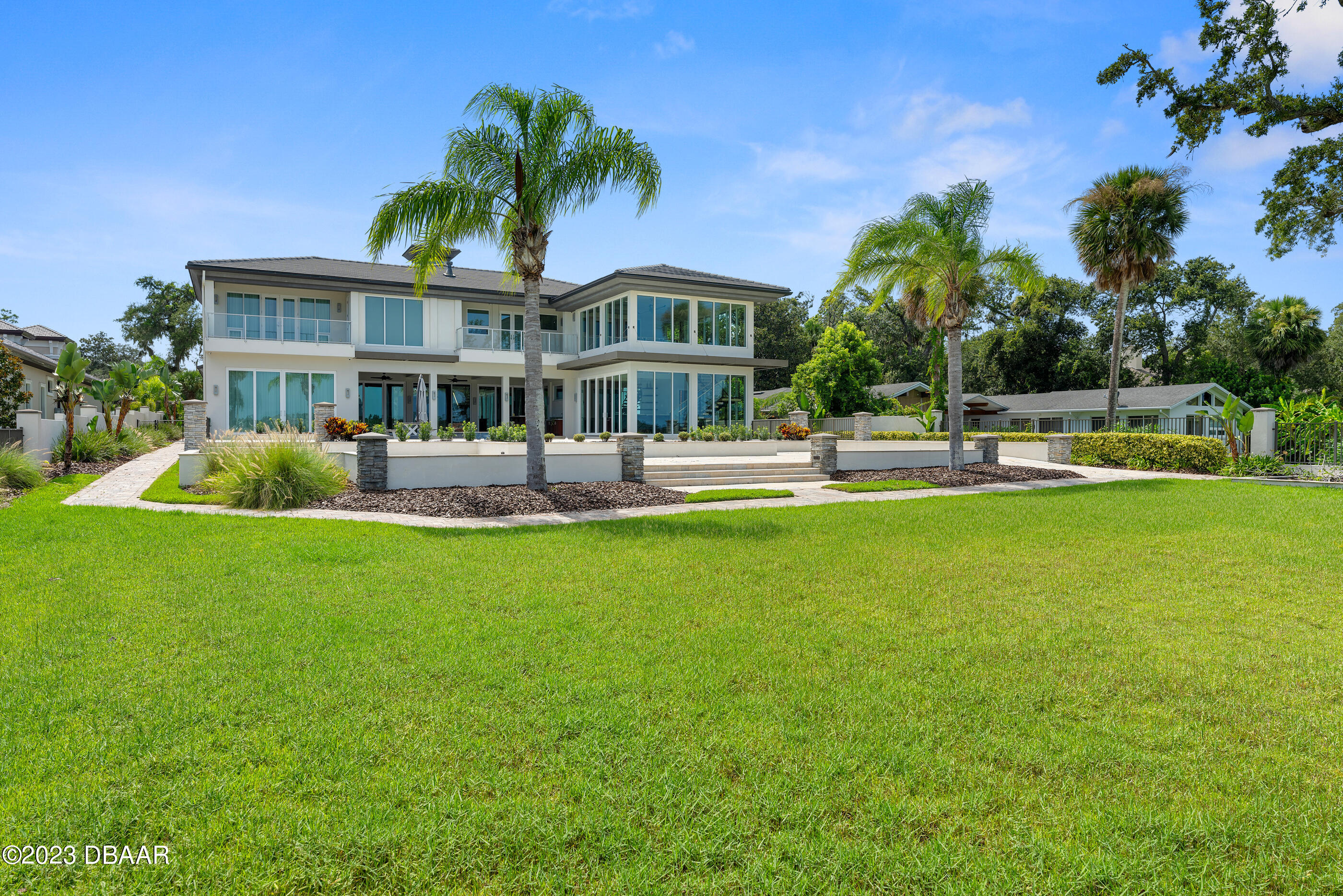 437 North Beach Street Ormond Beach, FL 32174 - Photo 135 of 162 a front view of a house with a yard table and chairs