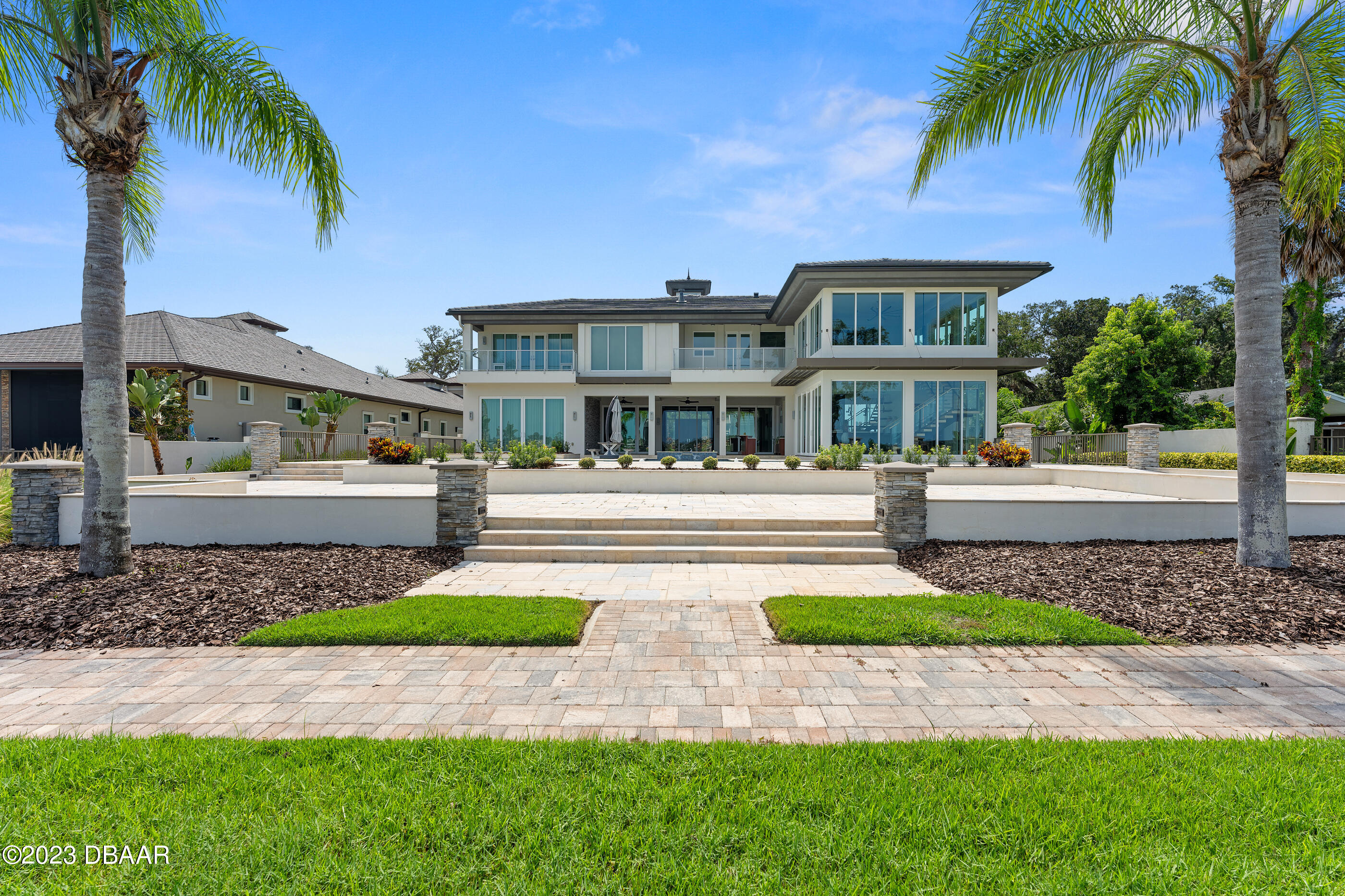 437 North Beach Street Ormond Beach, FL 32174 - Photo 137 of 162 a front view of a house with a yard and palm tree