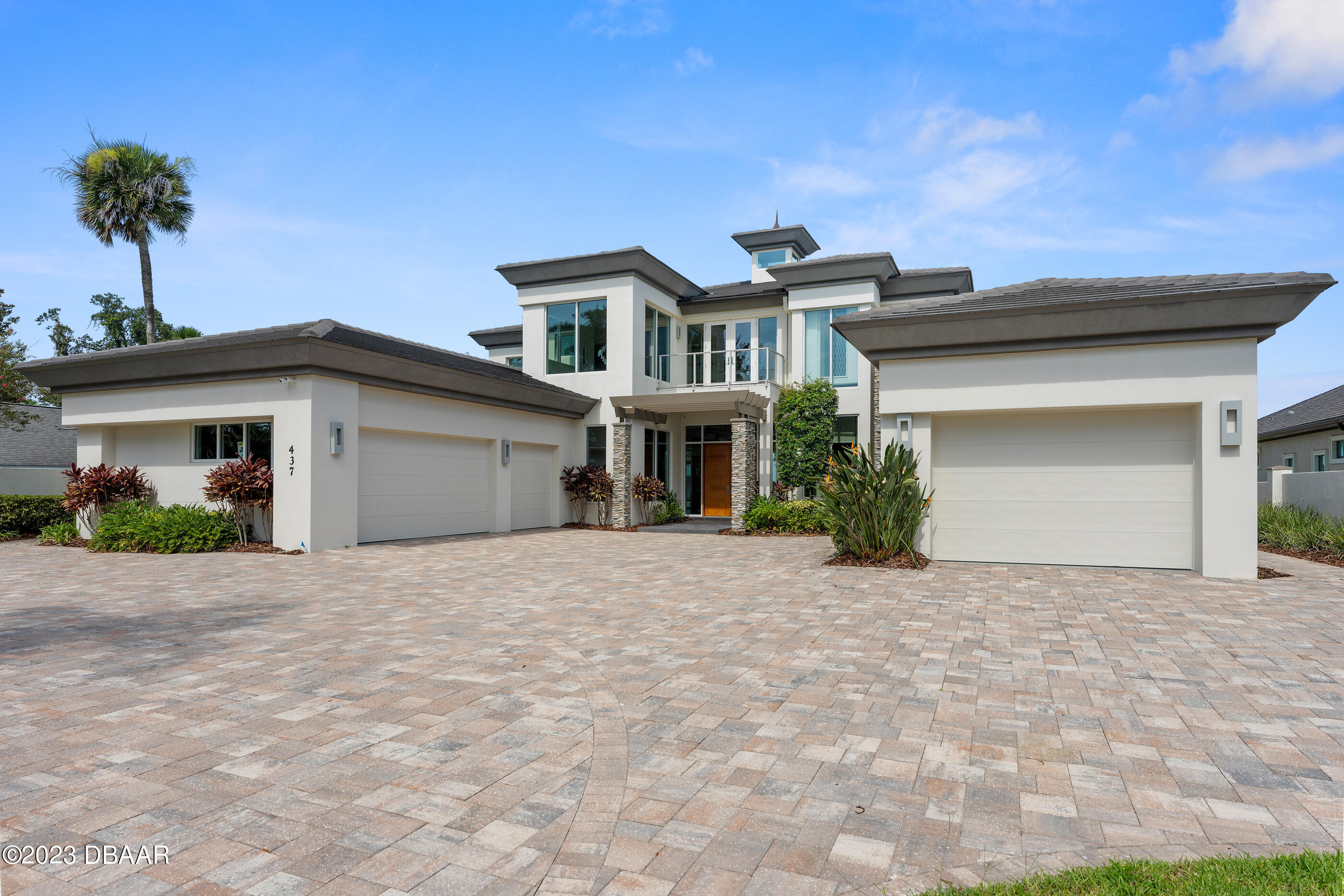 437 North Beach Street Ormond Beach, FL 32174 - Photo 146 of 162 a front view of a house with a yard and garage