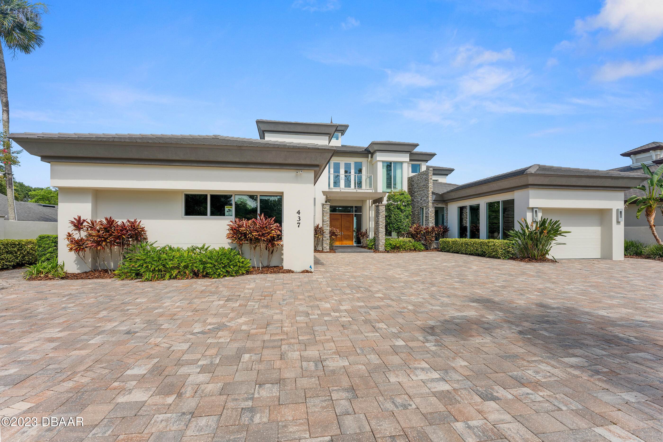 437 North Beach Street Ormond Beach, FL 32174 - Photo 147 of 162 a front view of a house with a yard and a garage