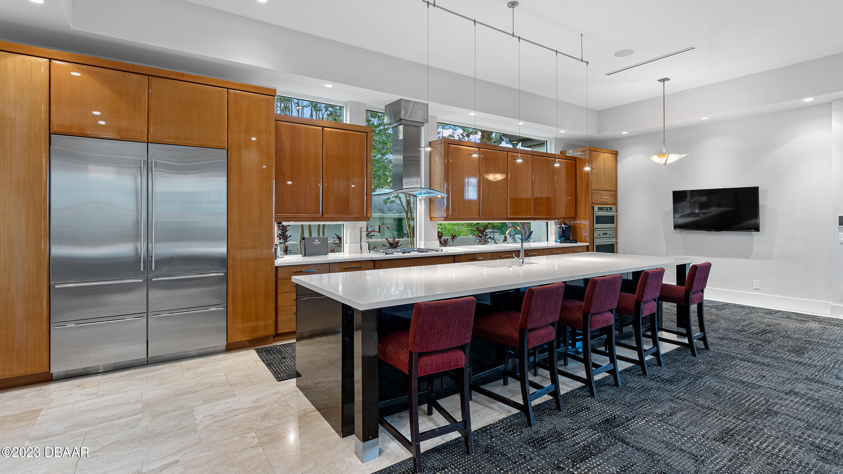 437 North Beach Street Ormond Beach, FL 32174 - Photo 27 of 162 a dining hall with stainless steel appliances kitchen island granite countertop a table chairs and a refrigerator
