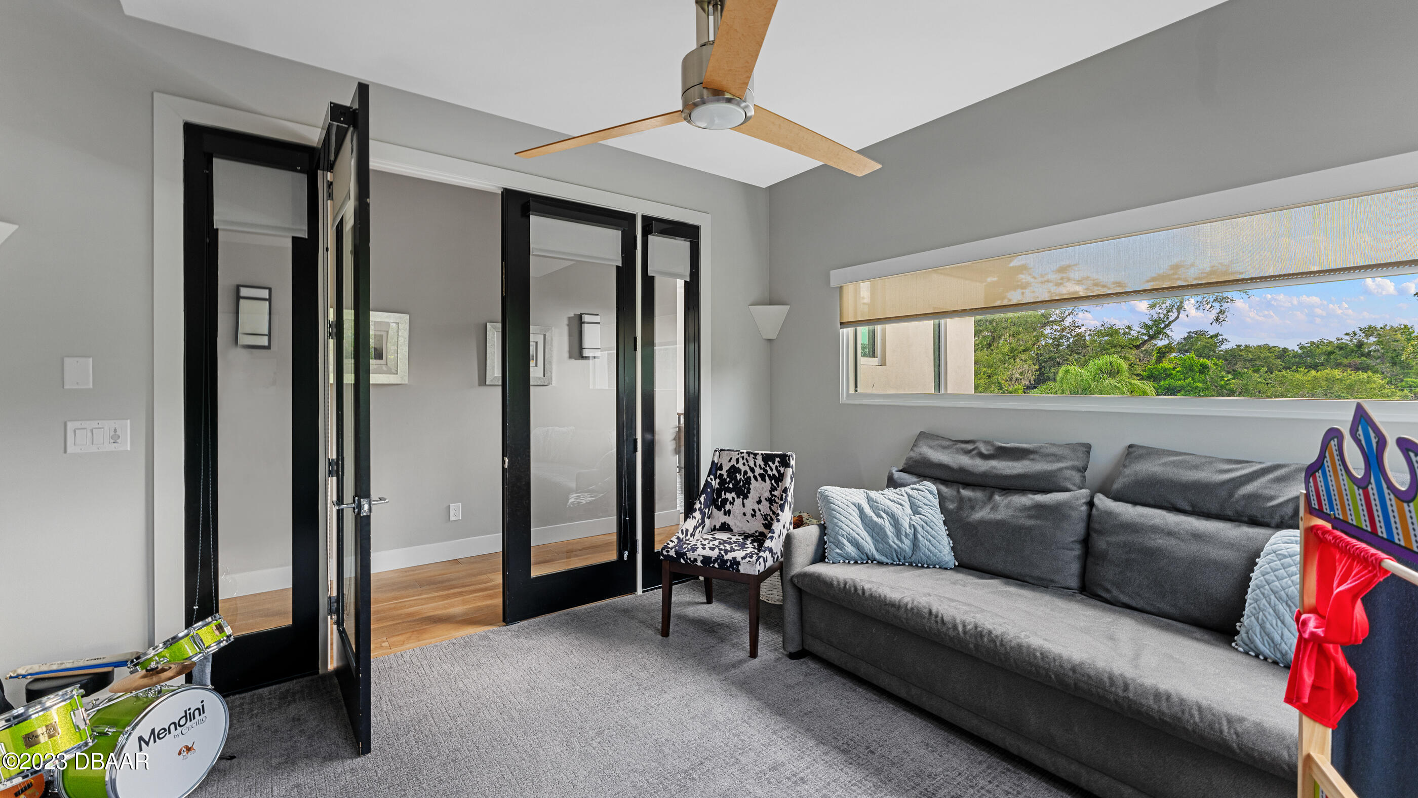 437 North Beach Street Ormond Beach, FL 32174 - Photo 64 of 162 a living room with furniture and a floor to ceiling window