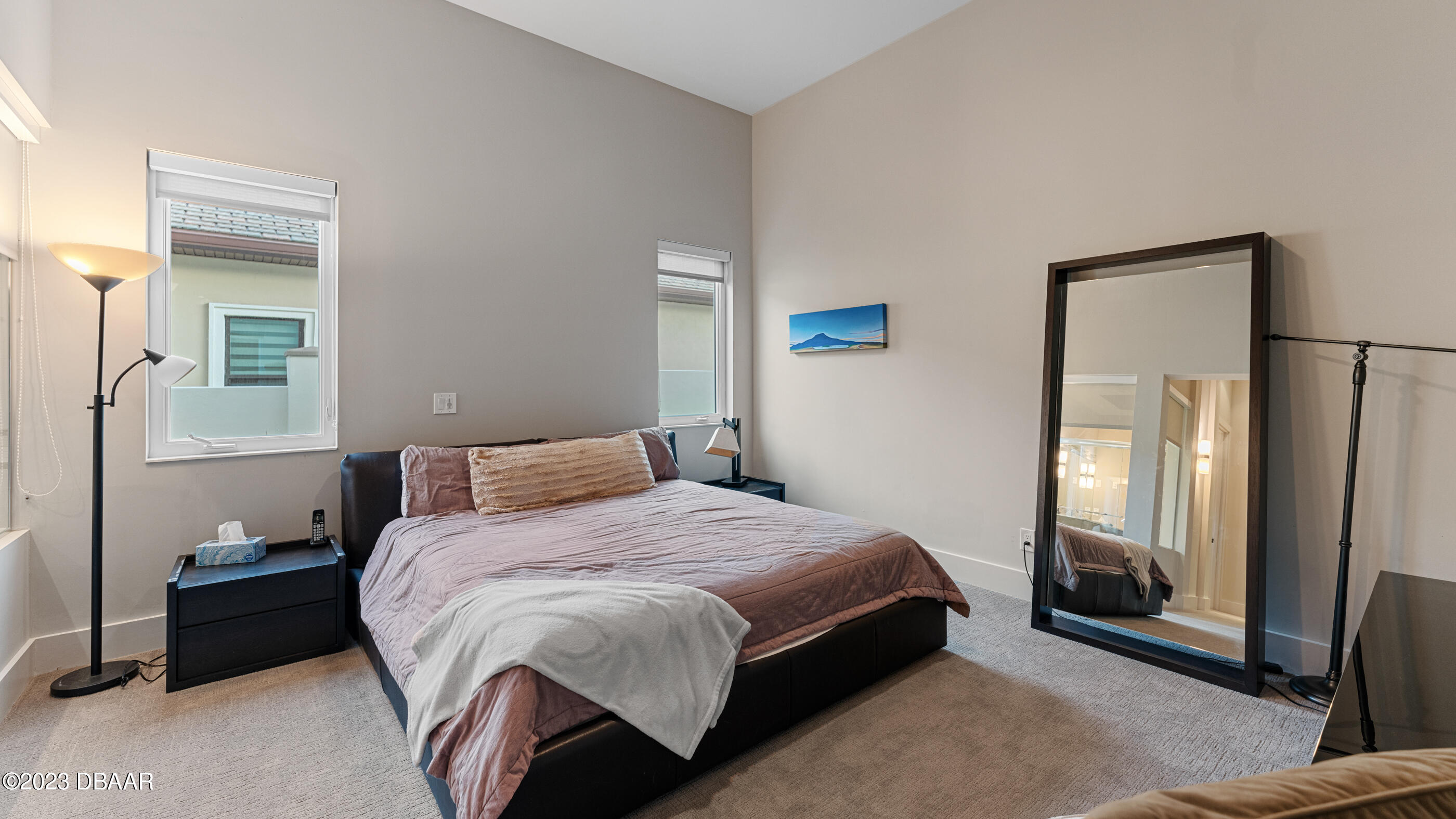 437 North Beach Street Ormond Beach, FL 32174 - Photo 78 of 162 a bedroom with a bed lamp and a mirror