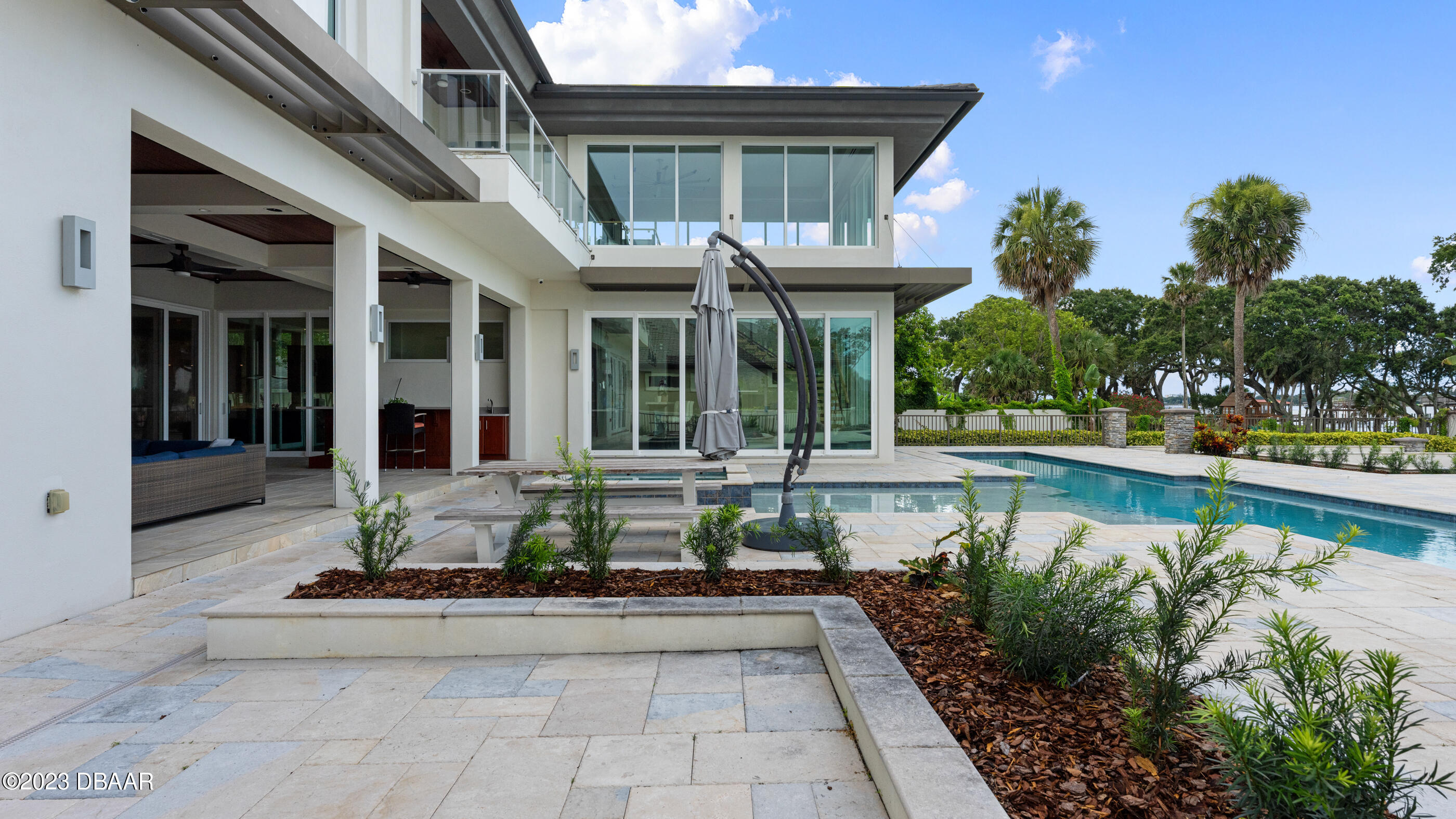 437 North Beach Street Ormond Beach, FL 32174 - Photo 95 of 162 a front view of a house with swimming pool and glass windows