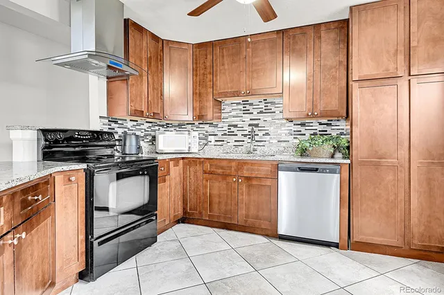 a kitchen with stainless steel appliances granite countertop a stove a sink and a refrigerator
